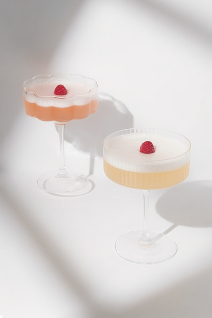Dried raspberry cocktail garnish in glass with vibrant red colour
